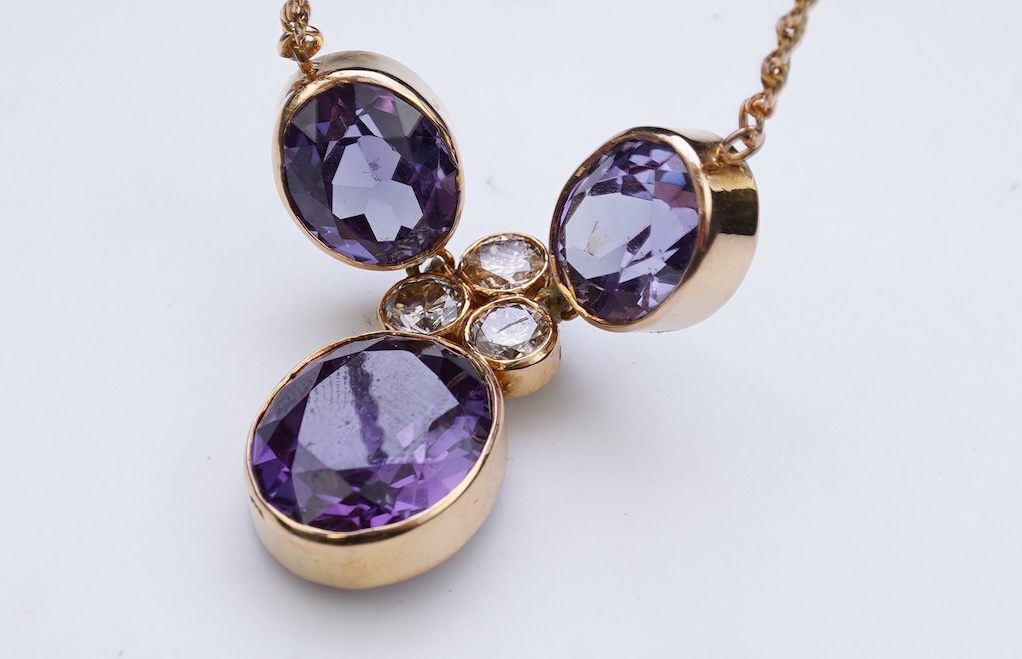 A synthetic colour-change sapphire and diamond pendant necklace